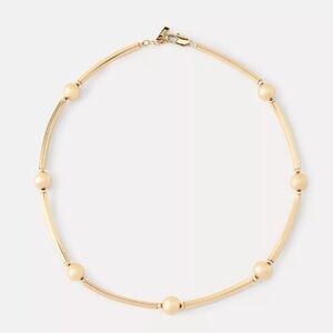 NWT. Zara Golden Necklace with circular and tubular metal pieces.